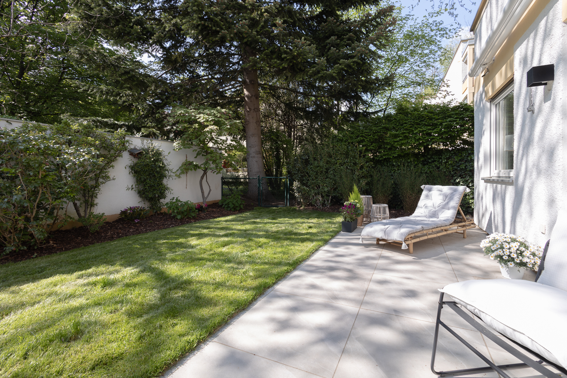 Neu angelegter Süd-West-Garten mit hell gefliester Terrasse